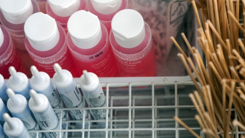 A closeup of swabs and solution bottles in a clinical lab