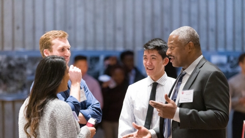 Alumni and students talk during a career night event in the medical school