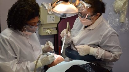 Dental providers at the Chandler health clinic examine a patient