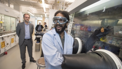 A graduate student leads visitors on a tour of lab in the new Chemistry and Chemical Biology building