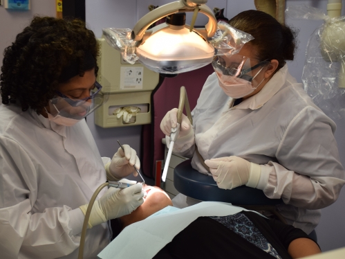Dental providers at the Chandler health clinic examine a patient