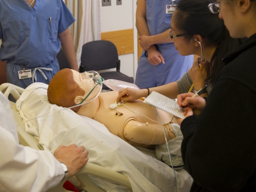 Medical students evaluate a simulation patient in the simulation lab