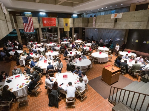 Alumni and students sit at round tables in the great hall on career night