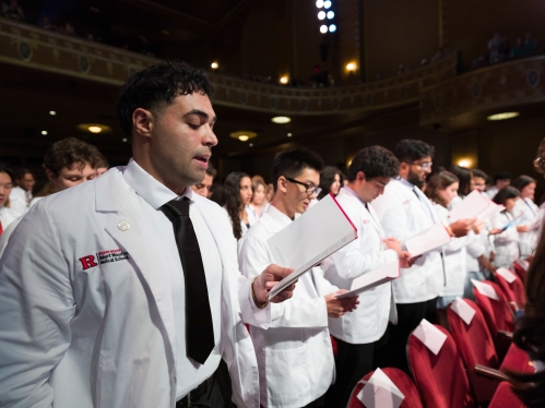 Med students reading the Hippocratic Oath