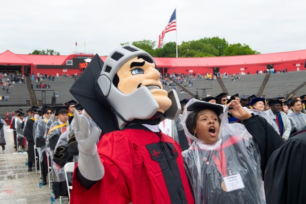 Professor of African American Studies Deborah Shuford (DC ’81) sings the alma mater with the Scarlet Knight.